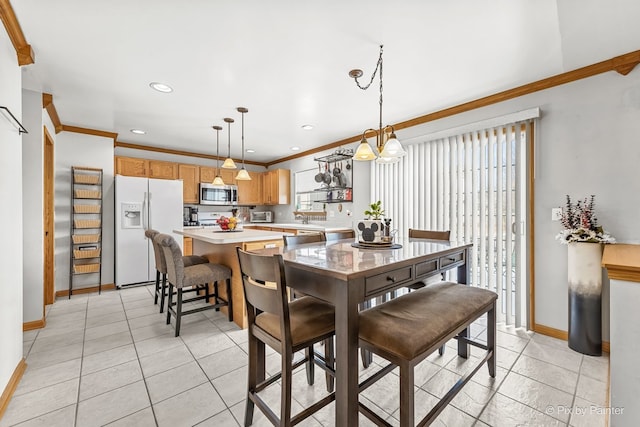 dining room featuring light tile patterned floors and crown molding