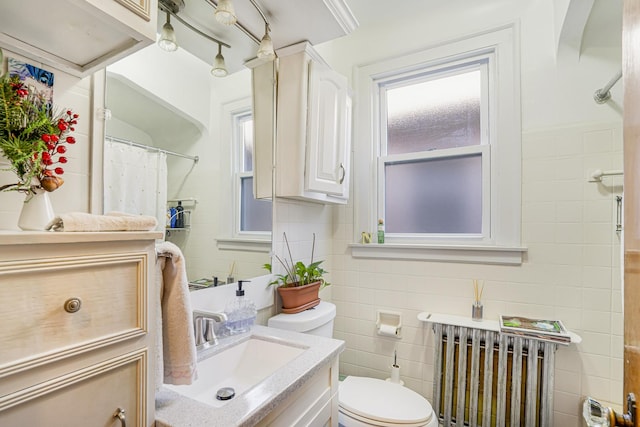 6159 S Karlov Ave, Chicago, IL 60629 - bathroom featuring toilet, radiator, vanity, and tile walls