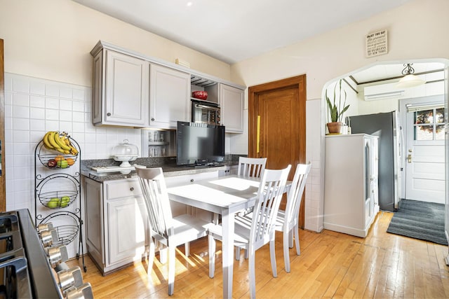6159 S Karlov Ave, Chicago, IL 60629 - kitchen featuring light hardwood / wood-style flooring, a wall mounted AC, and tasteful backsplash