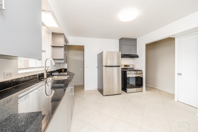 kitchen featuring sink, light tile patterned floors, gray cabinets, stainless steel appliances, and dark stone counters