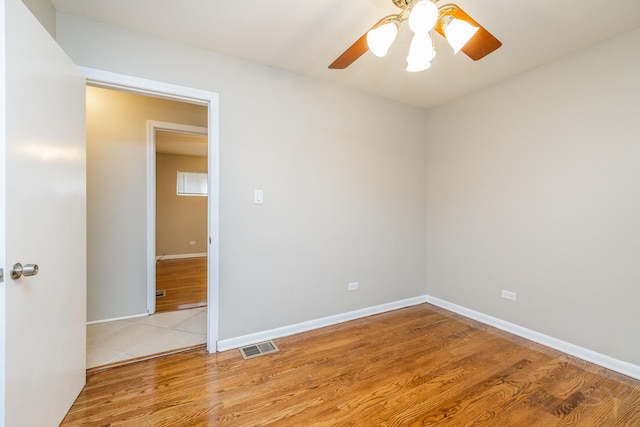 empty room with light hardwood / wood-style floors and ceiling fan