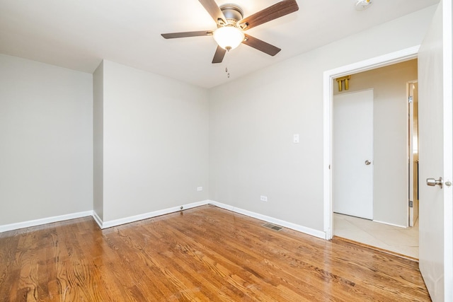 empty room featuring ceiling fan and light hardwood / wood-style flooring