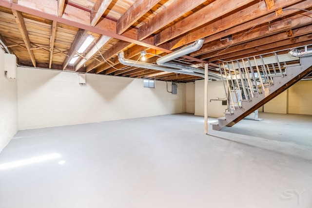 basement with electric panel and water heater