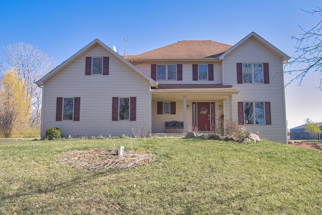 front facade with covered porch and a front yard