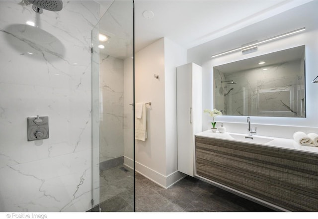 bathroom with vanity and a tile shower