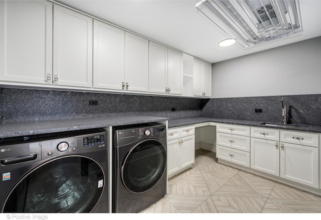 laundry area with sink, cabinets, and independent washer and dryer