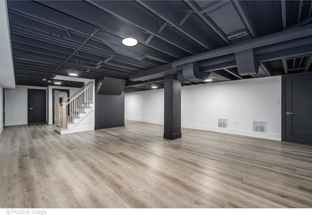 basement with hardwood / wood-style flooring