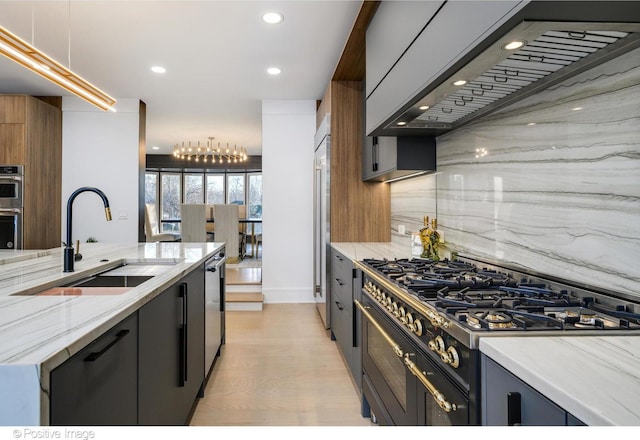 kitchen featuring decorative light fixtures, sink, decorative backsplash, and appliances with stainless steel finishes