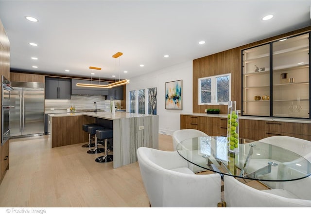 dining area with sink and light wood-type flooring