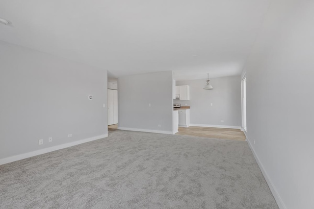 unfurnished living room with light carpet