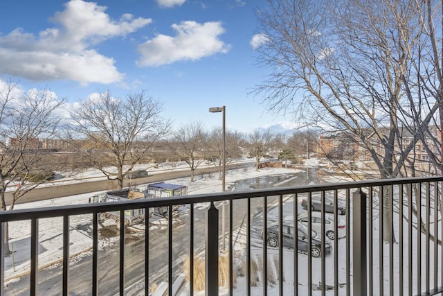 view of snow covered back of property