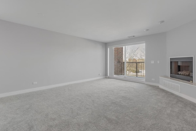 unfurnished living room with light colored carpet