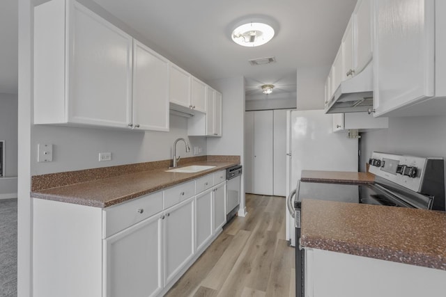 kitchen featuring stainless steel appliances, sink, and white cabinets