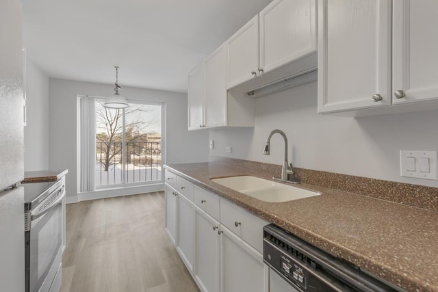 kitchen with dishwashing machine, sink, white cabinets, and light hardwood / wood-style flooring