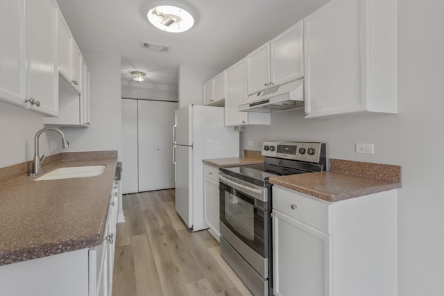 kitchen featuring light wood-type flooring, stainless steel electric range oven, sink, and white cabinets