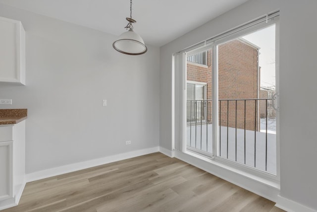 unfurnished dining area with light hardwood / wood-style flooring