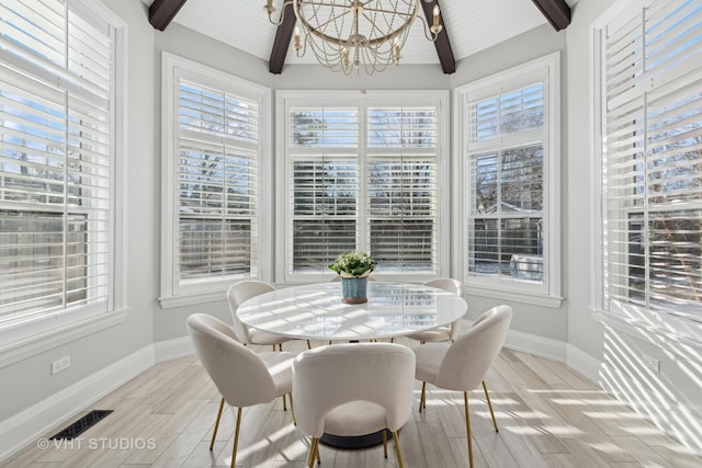 sunroom / solarium featuring vaulted ceiling with beams and a notable chandelier