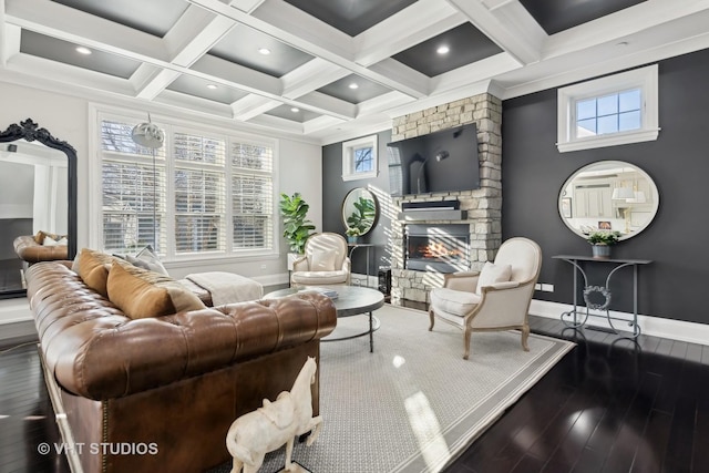 living room featuring dark hardwood / wood-style floors, coffered ceiling, a fireplace, and beam ceiling