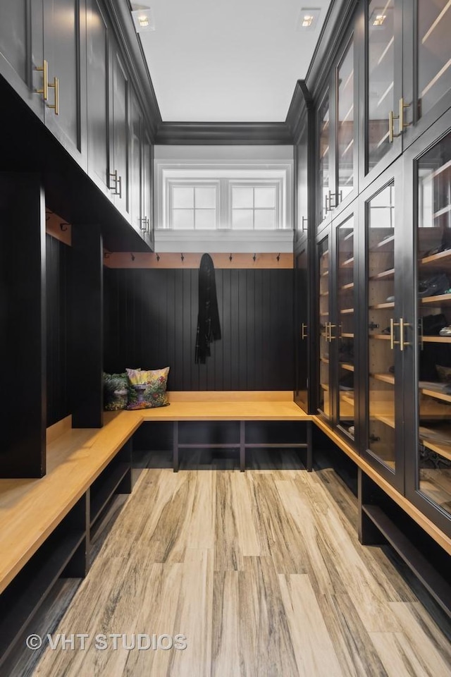 mudroom featuring wood-type flooring and ornamental molding