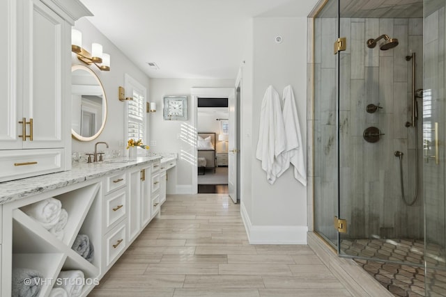 bathroom with vanity and a shower with shower door