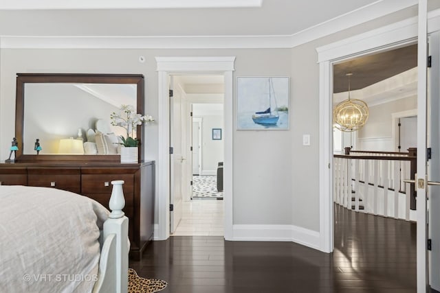 bedroom featuring crown molding, dark hardwood / wood-style floors, and a chandelier