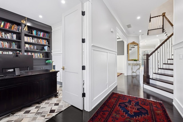 interior space with hardwood / wood-style flooring, crown molding, and built in shelves