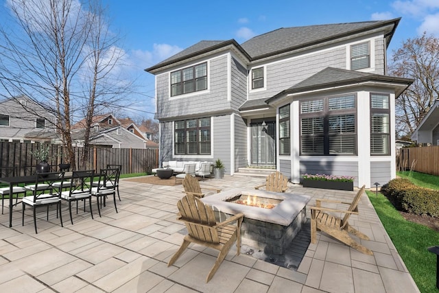 back of property featuring a patio and an outdoor fire pit