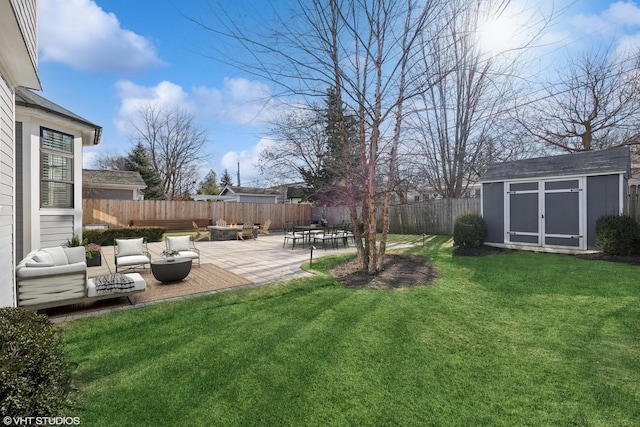 view of yard featuring a shed, an outdoor living space with a fire pit, and a patio