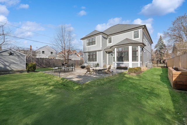 back of house with a fire pit, a shed, a yard, a patio, and central AC unit