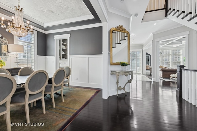 dining space featuring crown molding, plenty of natural light, and dark hardwood / wood-style flooring