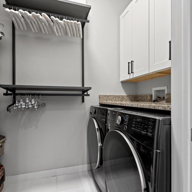 laundry room with cabinets, separate washer and dryer, and light tile patterned floors