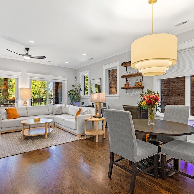 dining room with dark wood-type flooring and ornamental molding