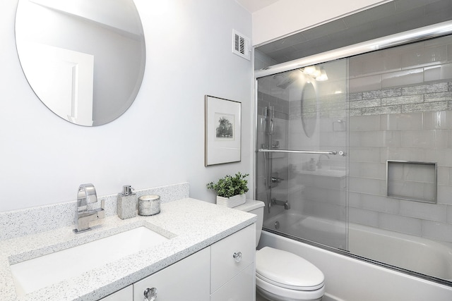 full bathroom with shower / bath combination with glass door, vanity, and toilet