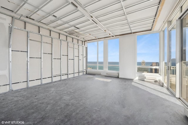 unfurnished sunroom with a water view