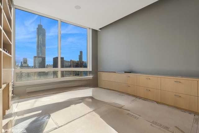 unfurnished room featuring a skyline view and light tile patterned floors
