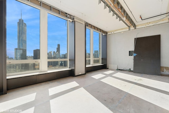 empty room with a skyline view and concrete floors