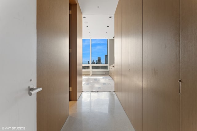 corridor with floor to ceiling windows and a view of city