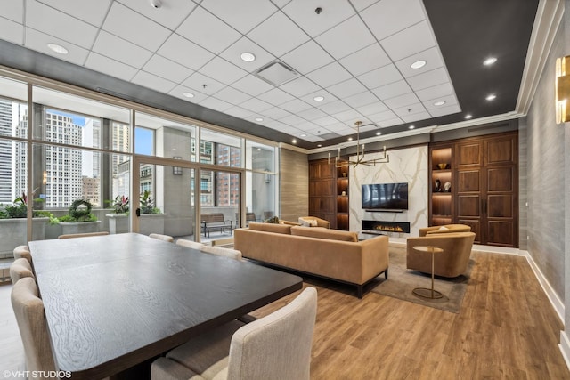 community lobby featuring a paneled ceiling, crown molding, and recessed lighting