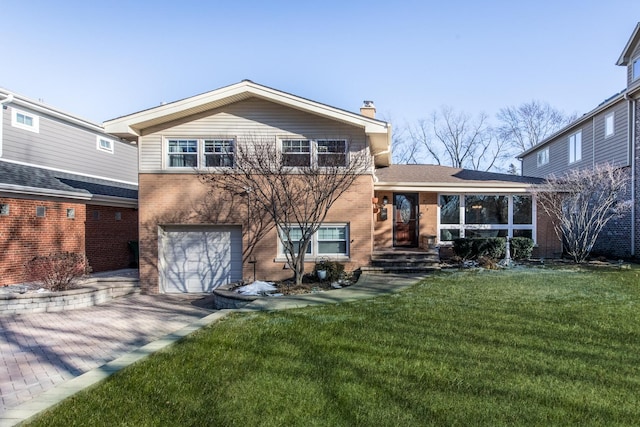 back of house featuring a garage and a lawn