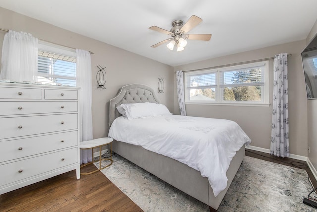 bedroom with ceiling fan and dark hardwood / wood-style floors