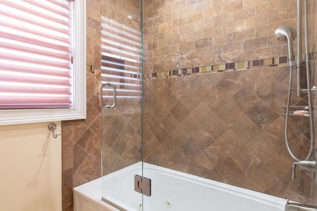 bathroom featuring shower / bath combination with glass door