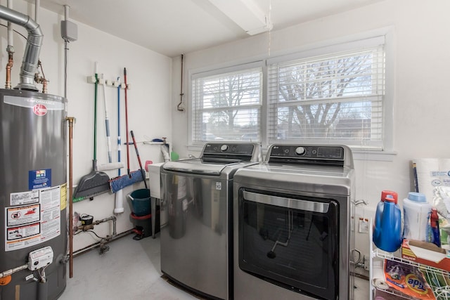 washroom featuring washing machine and dryer and water heater