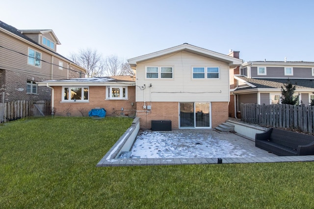 back of property with a yard and a patio area