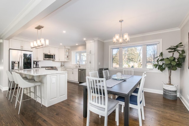 dining space featuring plenty of natural light, dark hardwood / wood-style flooring, sink, and a notable chandelier