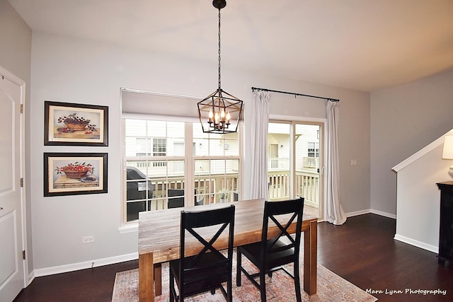 dining space featuring an inviting chandelier and dark hardwood / wood-style floors