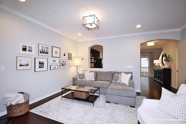 living room featuring wood-type flooring and crown molding