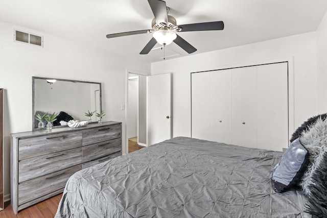 bedroom with ceiling fan, wood-type flooring, and a closet