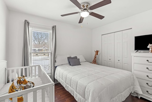 bedroom with a closet, dark hardwood / wood-style floors, and ceiling fan