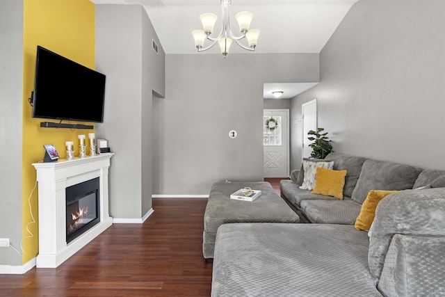 living room featuring dark wood-type flooring and a notable chandelier