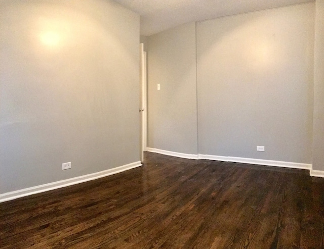 unfurnished room featuring dark hardwood / wood-style floors